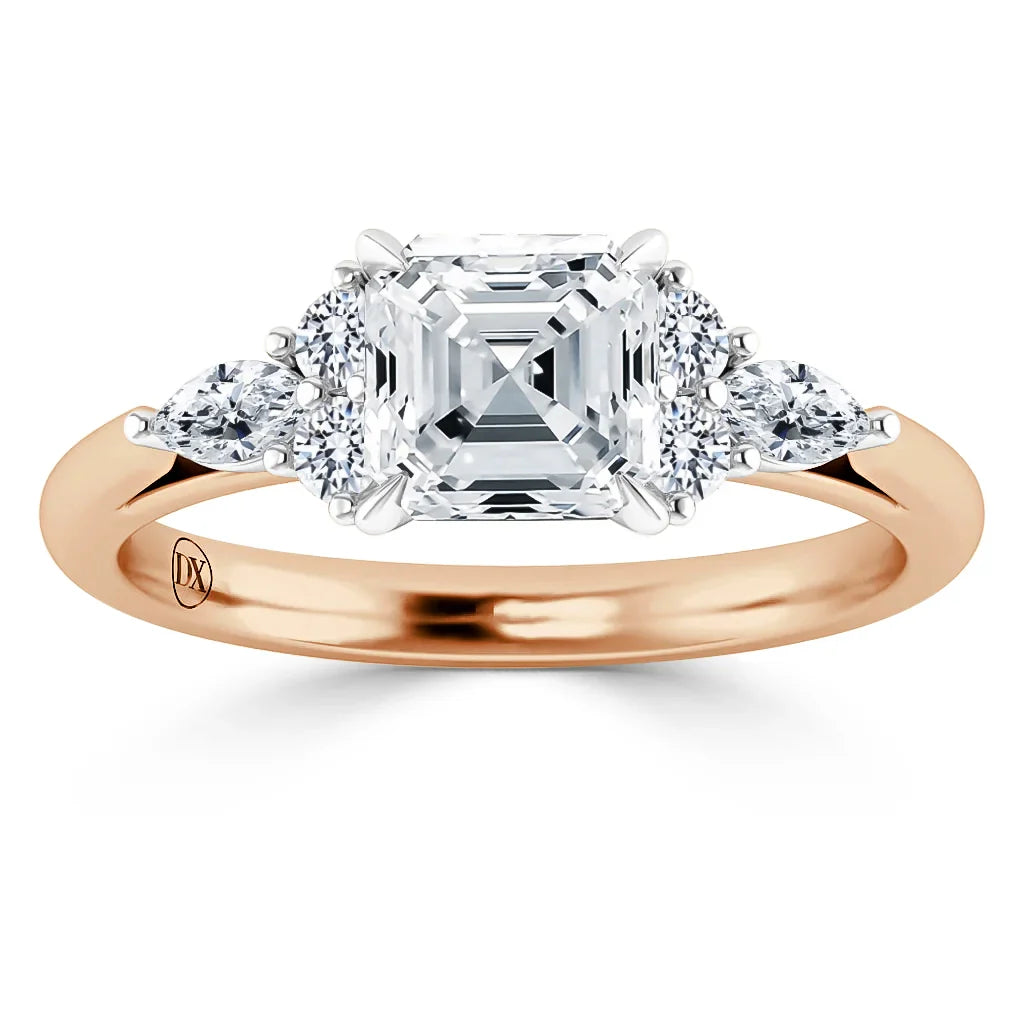 Rose gold ring with an Asscher-cut center diamond, flanked by four round and pear-shaped accent diamonds.