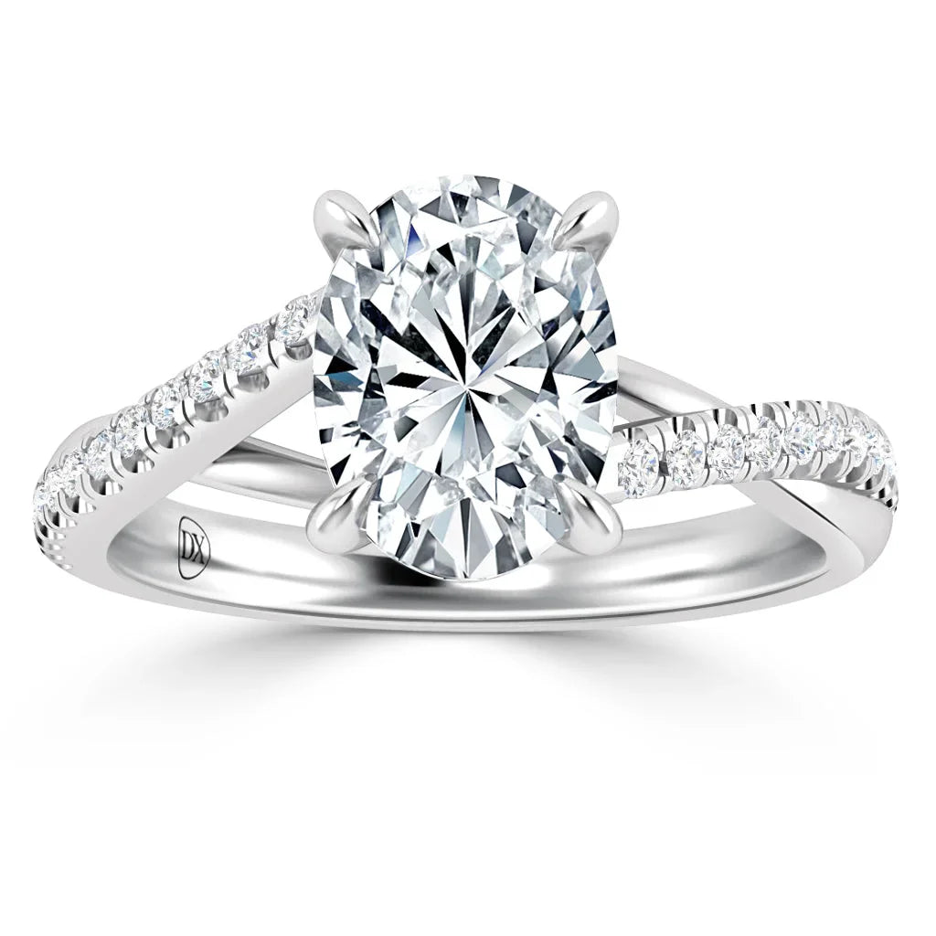 Oval diamond solitaire ring with split shank band accented by small round diamonds on a white background.