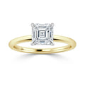 Gold band ring with a square, emerald-cut diamond in a four-prong setting on a white background.