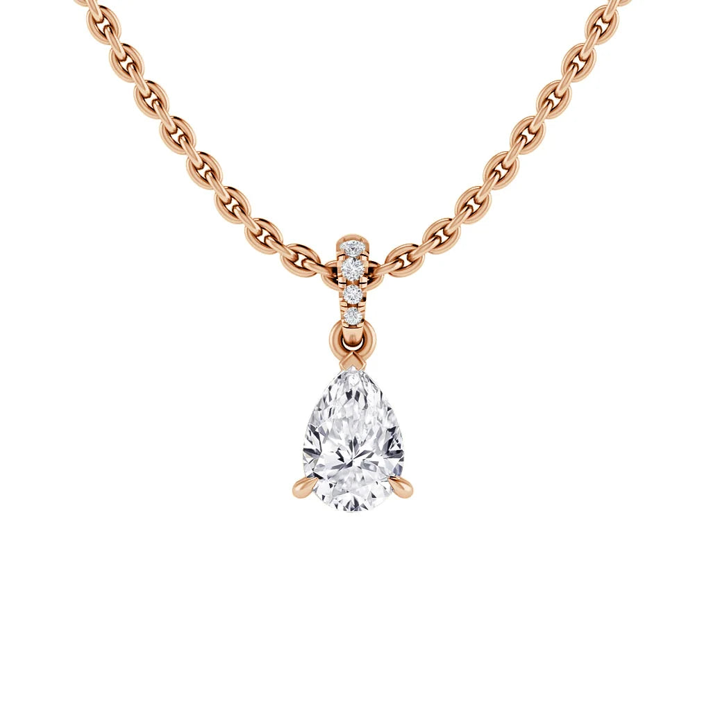 Rose gold chain necklace with a pear-shaped diamond pendant and three small round diamonds on the bale.