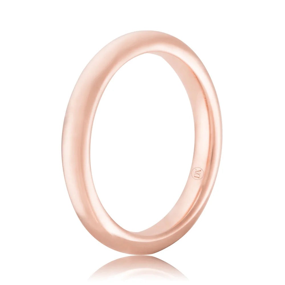 A simple, polished rose gold ring with a smooth, rounded band on a white background.