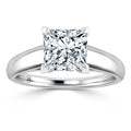 A silver band ring with a large, square-cut diamond solitaire set in four prongs, on a white background.