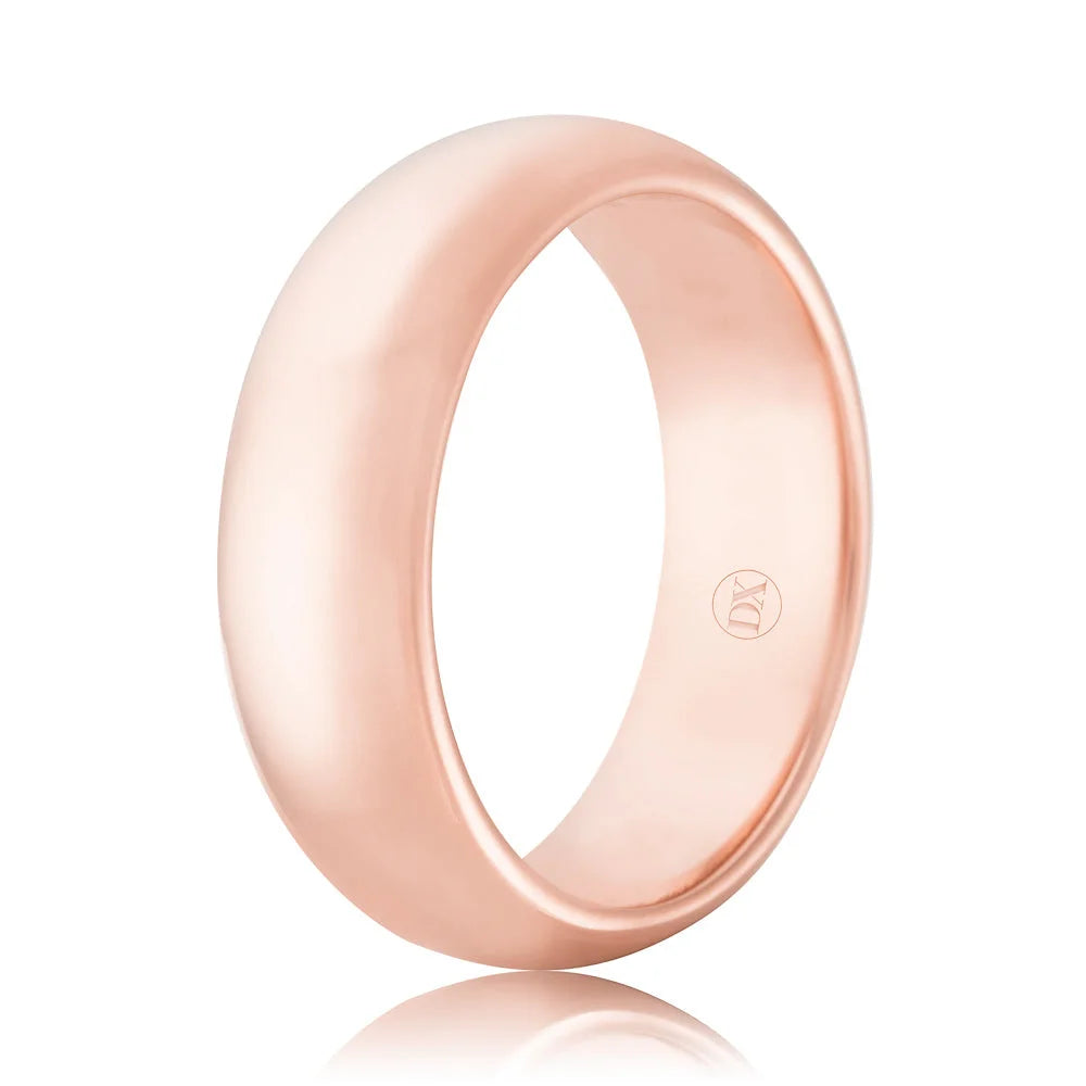 A smooth, polished rose gold ring with a rounded shape and a small engraved logo inside the band.