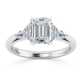 Platinum ring with an emerald-cut center diamond and three round side diamonds on each side.