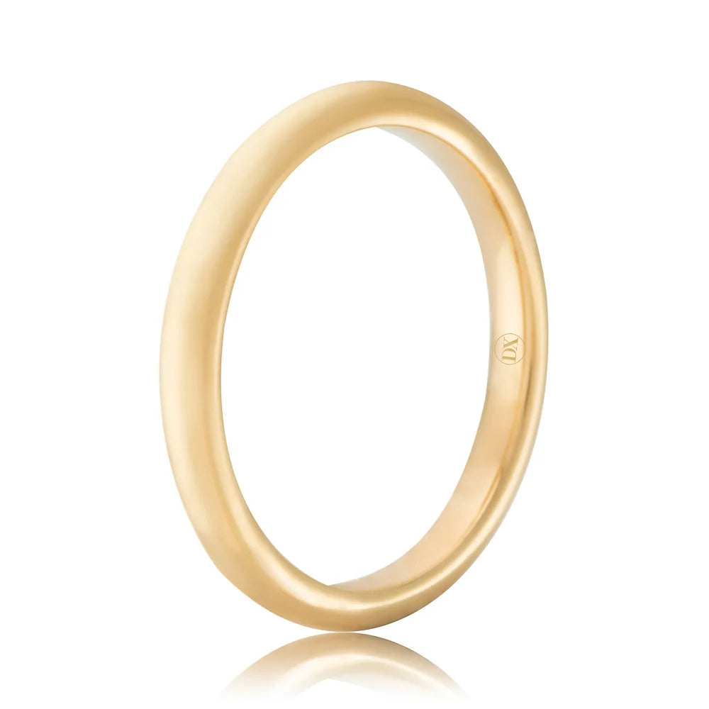 A simple, polished yellow gold ring with a small engraved symbol on the inner band, shown on a white background.