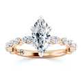 A marquise-cut diamond ring with a rose gold band accented by smaller round and marquise diamonds.