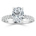 A white gold ring with an oval-cut diamond center stone and smaller diamonds set along the band.