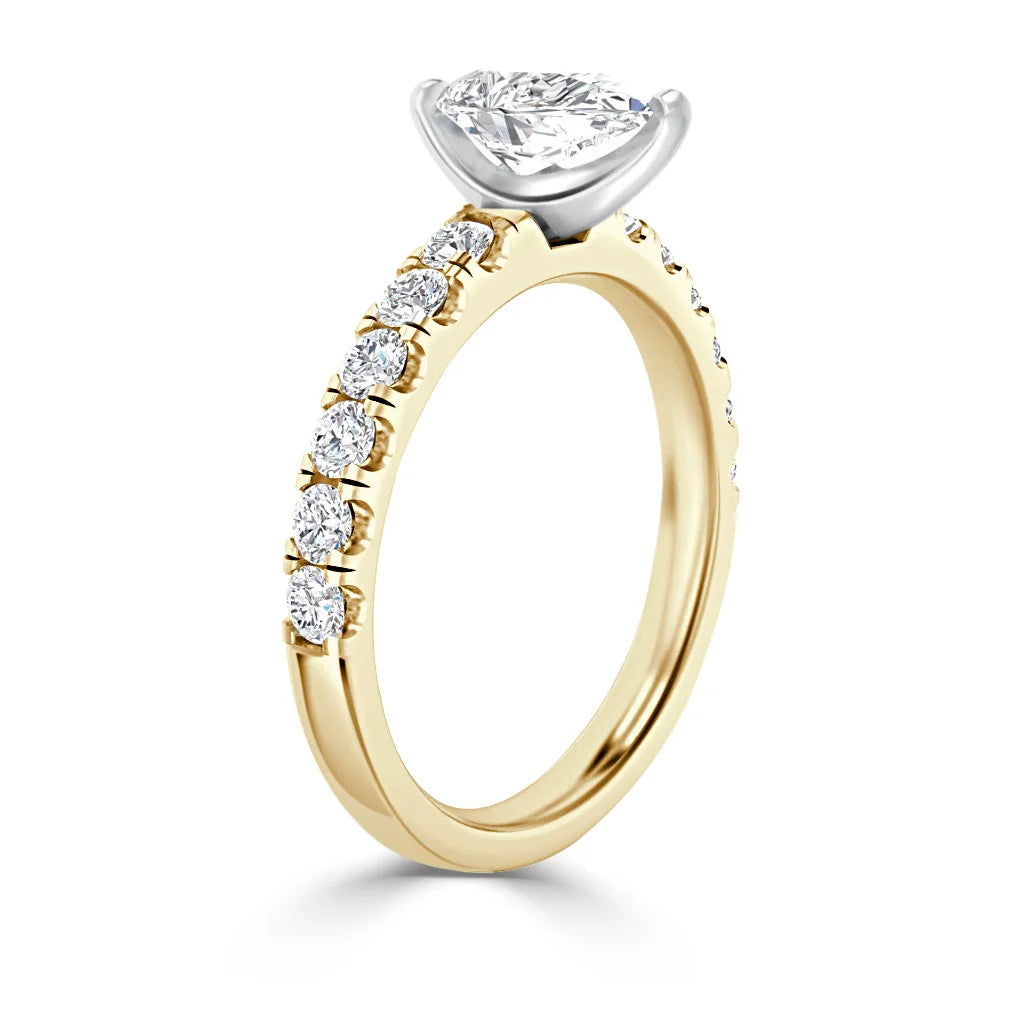 A gold ring with a marquise diamond center stone and small round diamonds along the band.