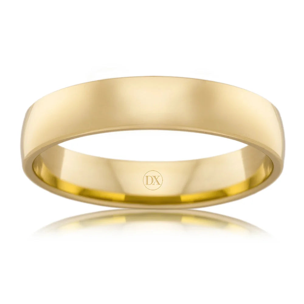 A plain, polished yellow gold ring with a smooth surface and a small DX engraving inside the band.