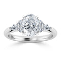 A white gold ring with an oval center diamond and four smaller round and marquise side diamonds.
