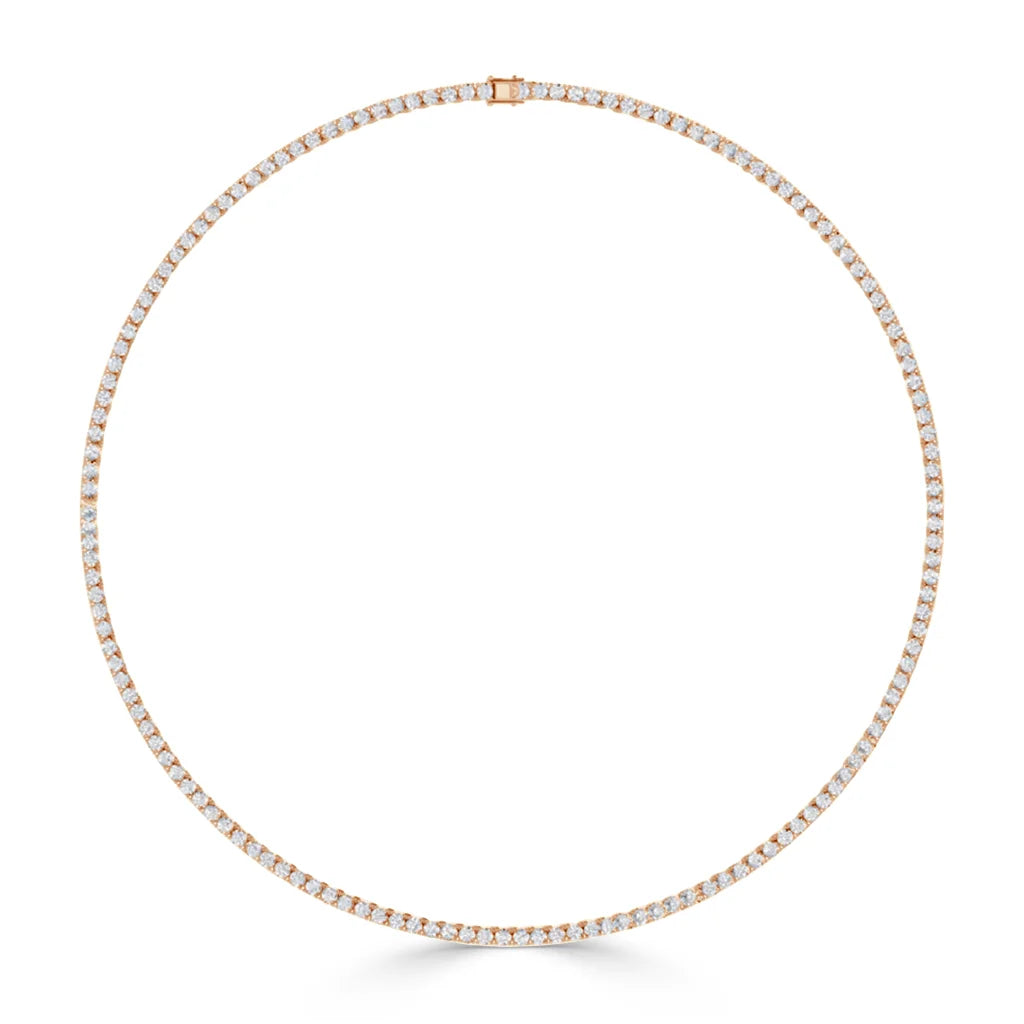 A thin, circular gold tennis necklace with evenly spaced white diamonds set all around.