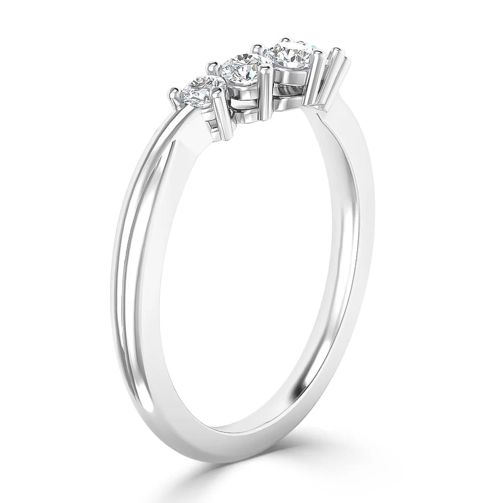 Silver ring with three round, sparkling diamonds set in a row on a thin, polished band, shown from the side.