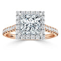 A rose gold ring with a large square-cut diamond and a double halo of smaller diamonds on the band.