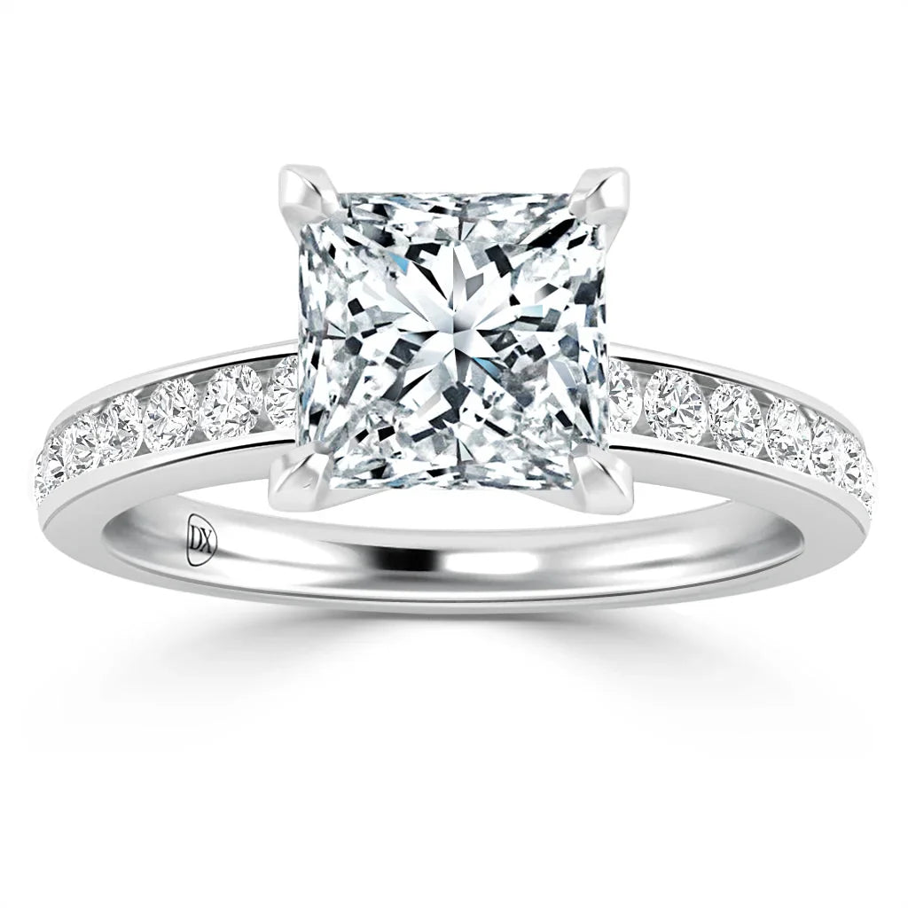 A platinum ring with a large princess-cut diamond center and smaller diamonds set along the band.