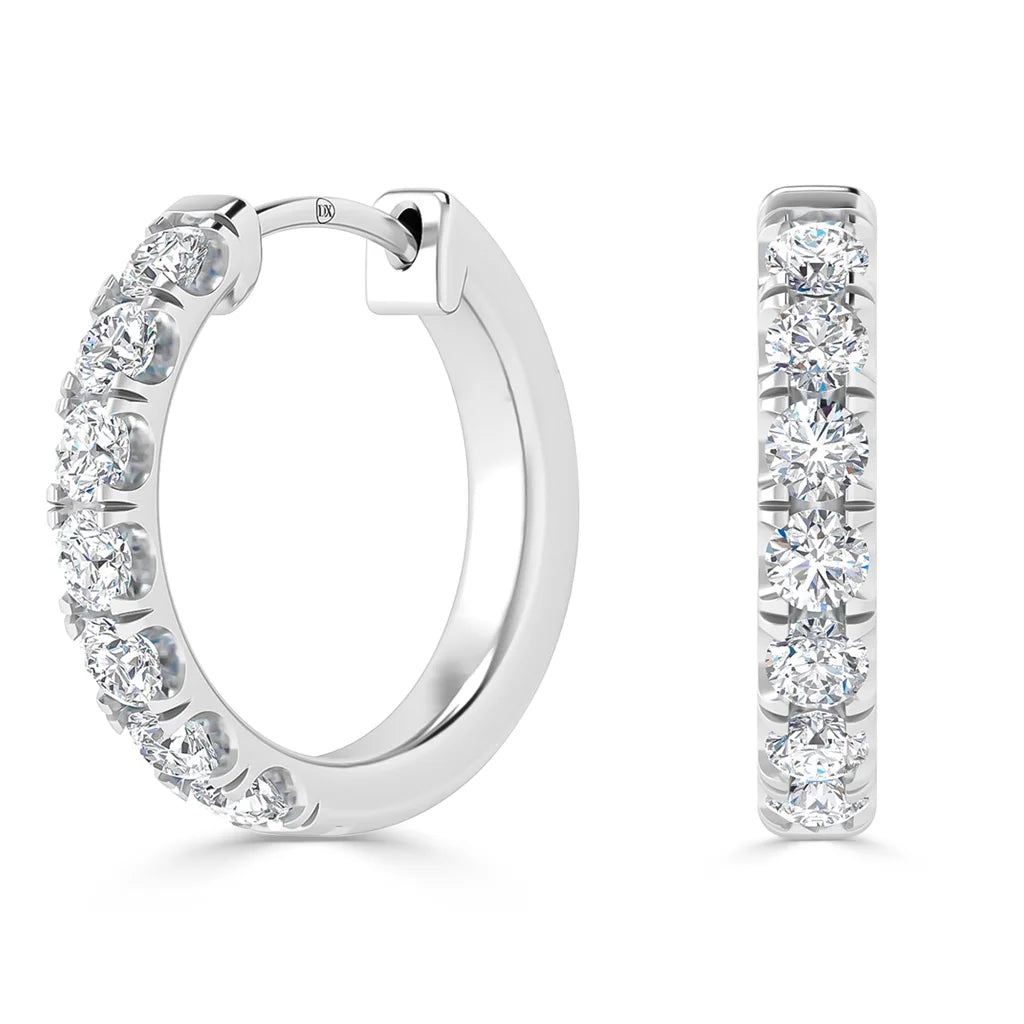 Two silver hoop earrings adorned with sparkling round-cut diamonds, shown from side and front views.