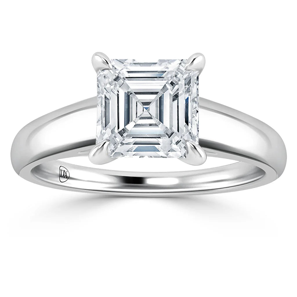 A silver ring with an Asscher-cut diamond set in a four-prong solitaire setting on a plain band.