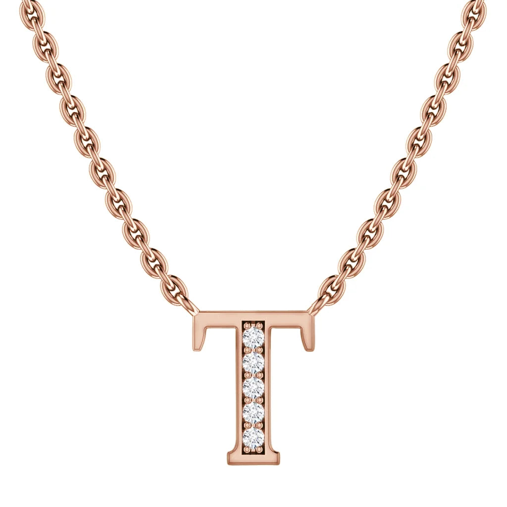 A rose gold necklace with a “T” pendant encrusted with small, sparkling diamonds on a fine chain.