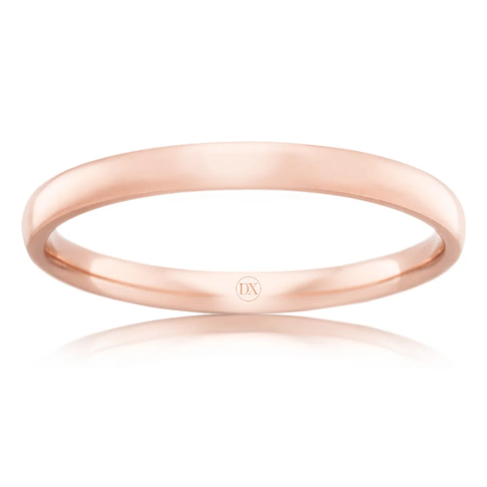 A simple, polished rose gold band with a subtle “DX” engraving on the inside, set against a white background.