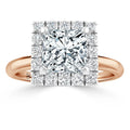 A rose gold ring with a square-cut diamond center, surrounded by a double halo of smaller round diamonds.
