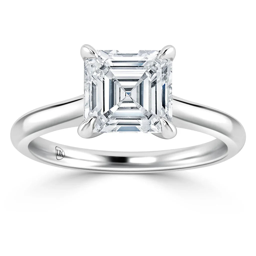A solitaire ring with an Asscher-cut diamond on a simple, polished platinum band.