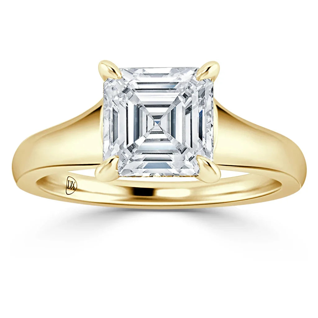 Gold band ring with a square, Asscher-cut diamond solitaire set in four prongs, shown on a white background.