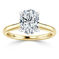 A gold ring with a large, oval-cut diamond solitaire held by four prongs on a plain band.
