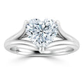 A heart-shaped diamond ring with a split shank platinum band against a white background.