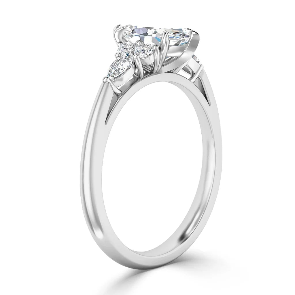 Side view of a silver ring with a large central diamond and two smaller diamonds in an elegant prong setting.