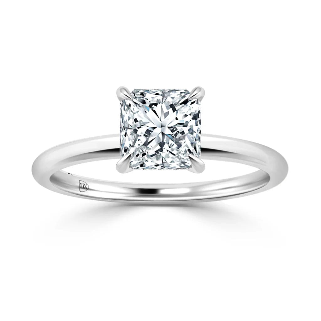 A solitaire engagement ring with a princess-cut diamond set on a simple, polished white gold band.
