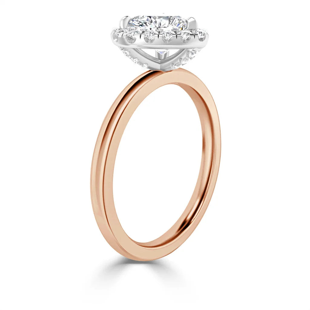 A rose gold ring with a round, elevated diamond halo setting and a slim, polished band.