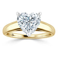 Gold ring with a heart-shaped diamond solitaire set in a prong setting, shown on a white background.