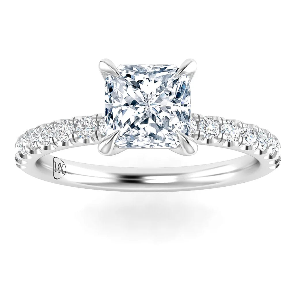 A white gold ring with a large princess-cut diamond and smaller diamonds along the band.