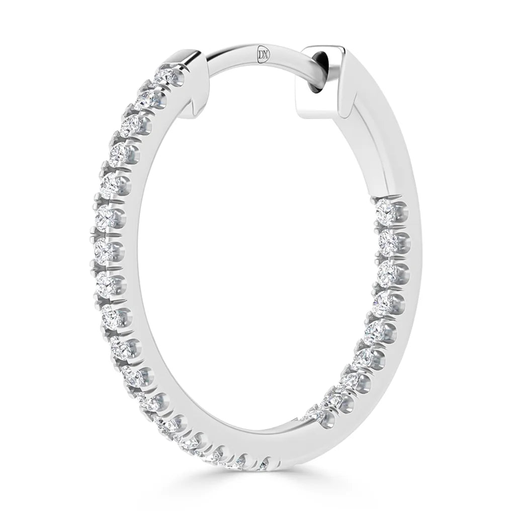 A silver hoop earring encrusted with small round diamonds on the front outer edge, shown on a white background.