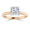 A solitaire princess-cut diamond ring with a rose gold band and four prong setting, viewed from the front.