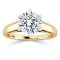 Yellow gold band ring with a large round brilliant diamond in a six-prong solitaire setting, on a white background.