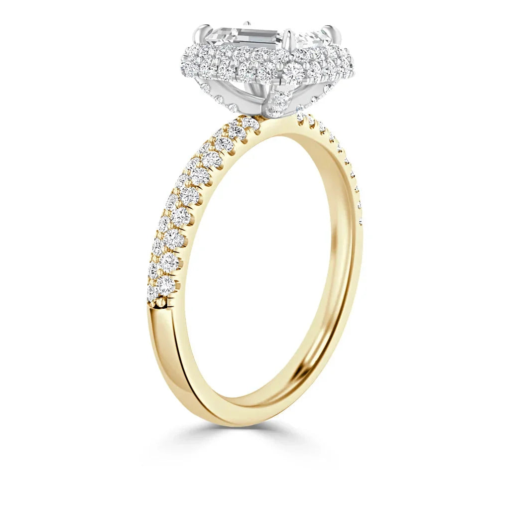 A gold ring with a diamond-encrusted band and a large rectangular diamond in a raised, halo setting.