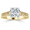 Gold ring with a large cushion-cut diamond and intricate, swirling filigree design on the band.