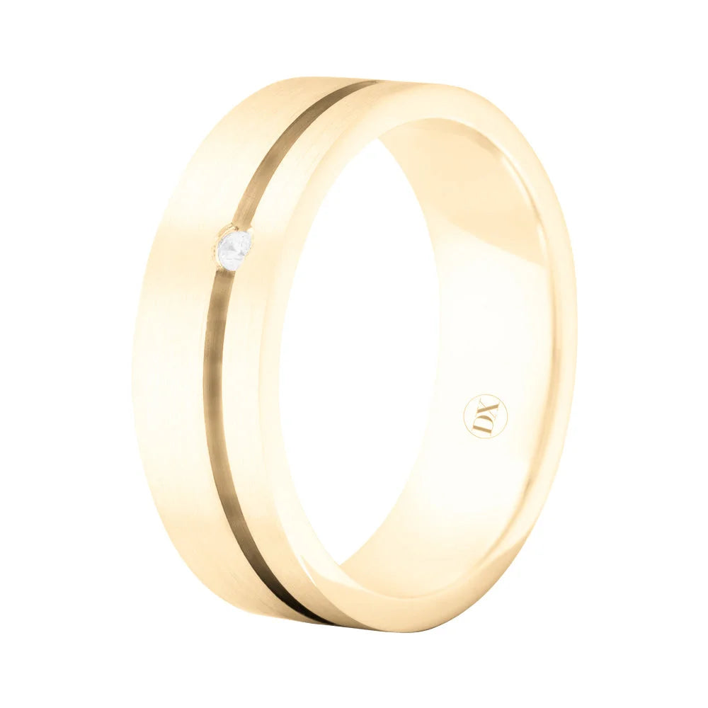 Gold ring with a single small diamond and a thin, dark stripe running around the band, viewed at an angle.