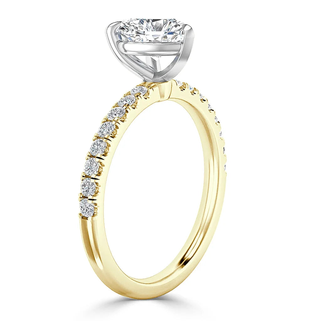 Gold ring with round side diamonds and a large solitaire diamond in a white gold prong setting, shown upright.