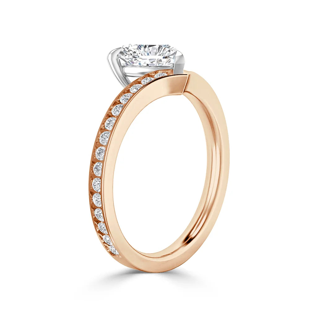 Rose gold ring with side-set diamonds and a large round solitaire diamond in a prong setting, on white background.