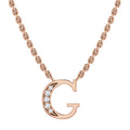 Rose gold necklace with a “G” pendant, partially adorned with small sparkling diamonds on the left side.