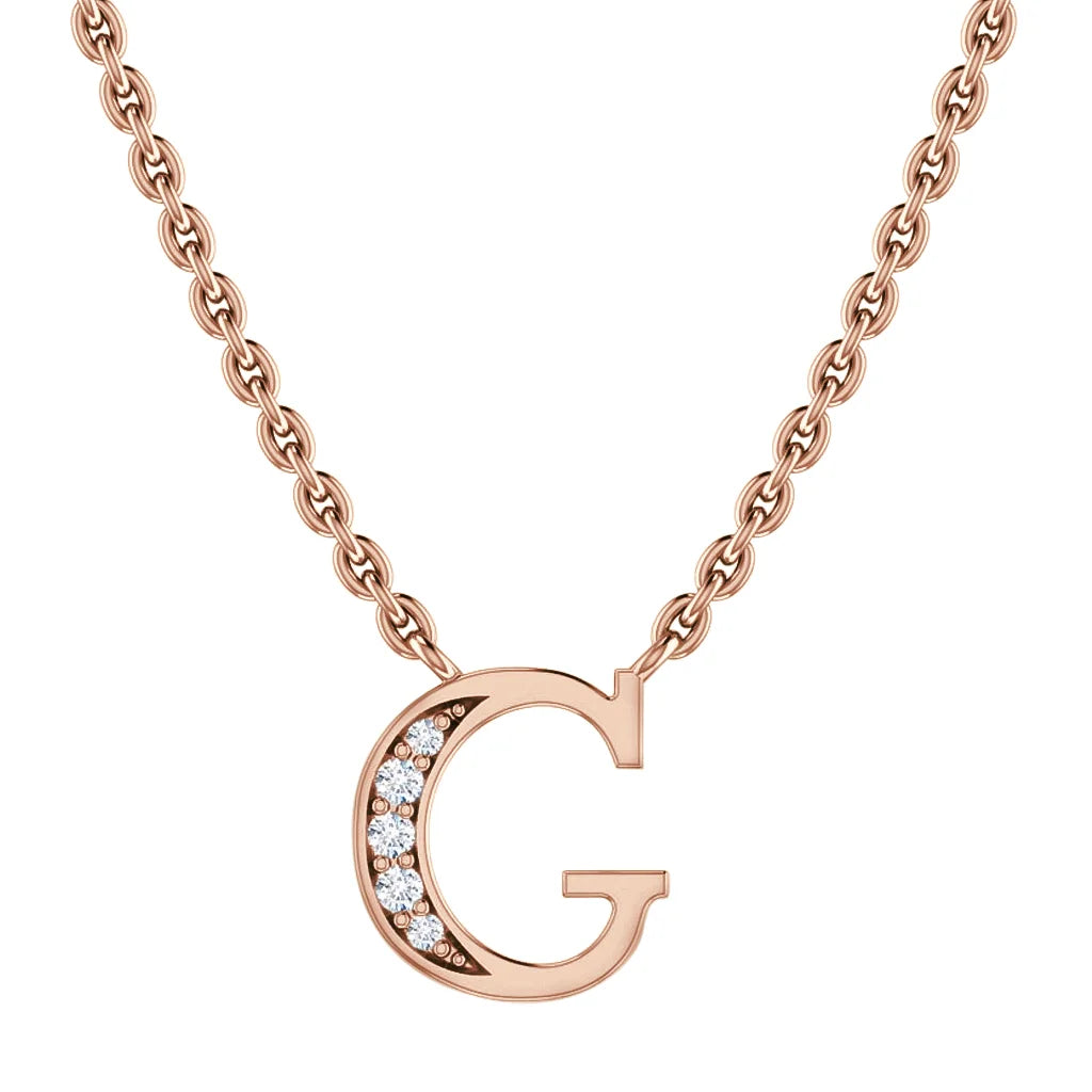 Rose gold necklace with a “G” pendant, partially adorned with small sparkling diamonds on the left side.