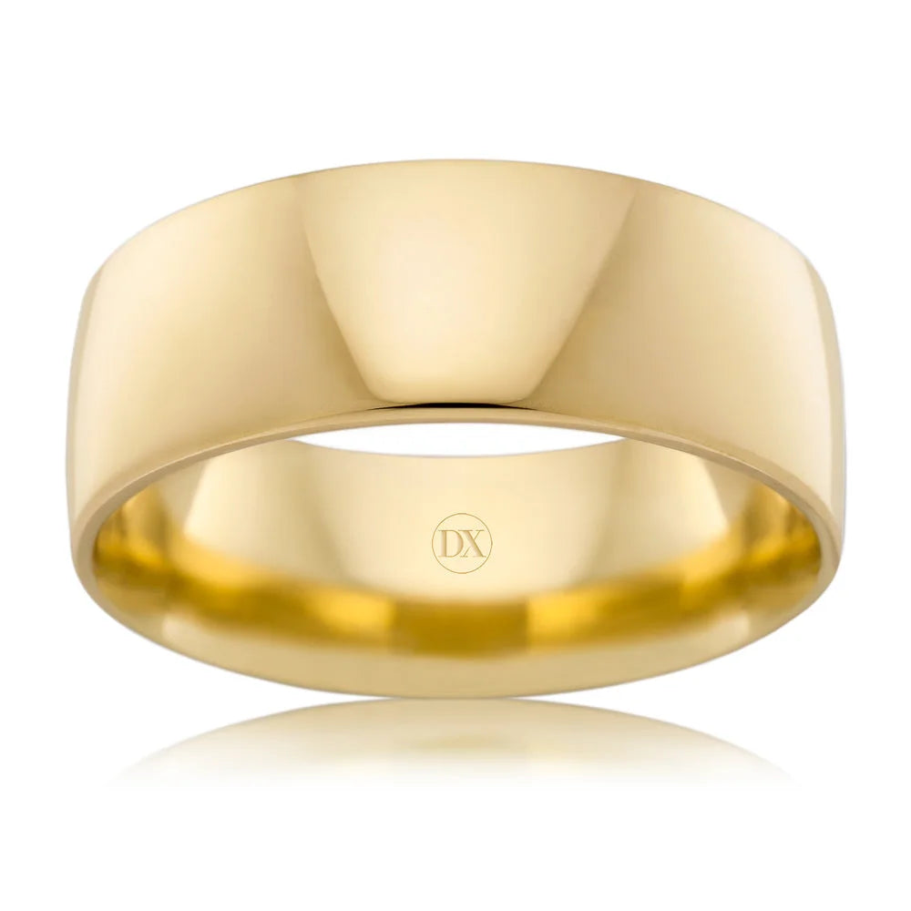 Wide, polished yellow gold band ring with smooth surface and subtle DX engraving inside.