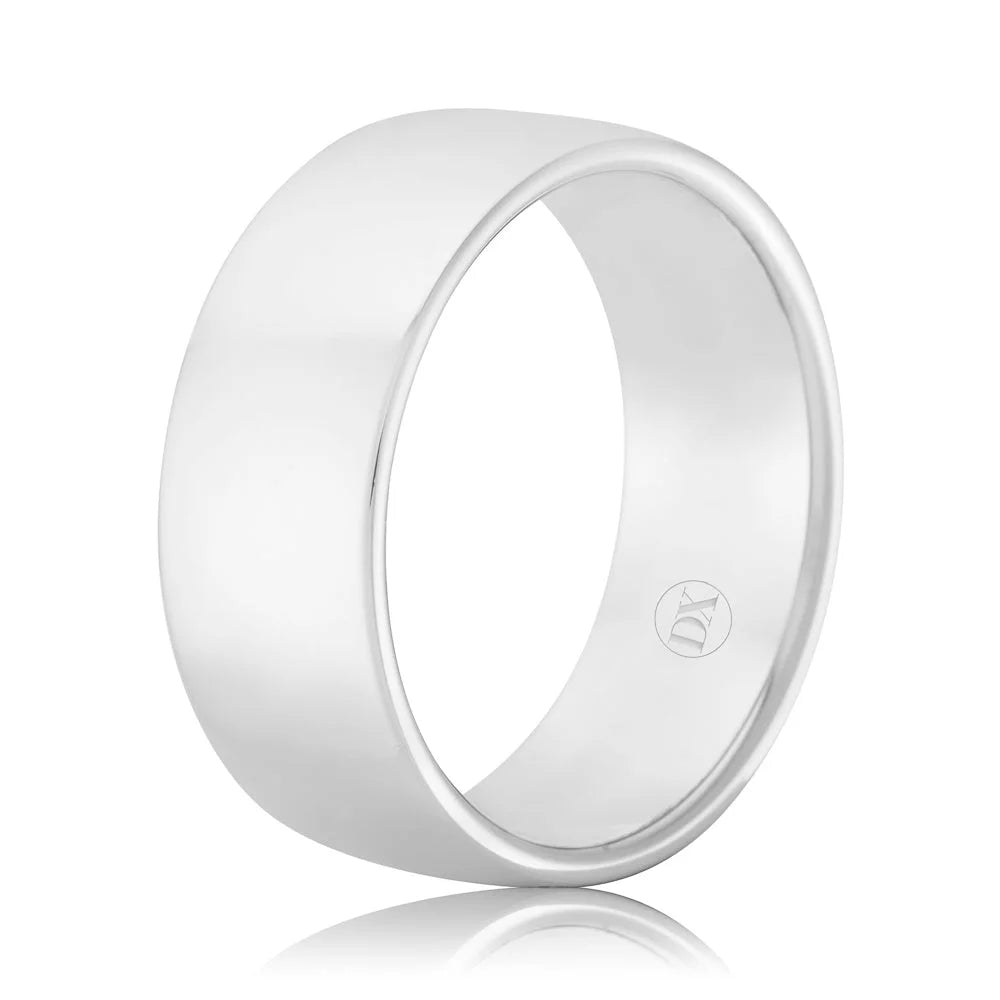 A wide, polished silver ring with a smooth surface and a small engraved logo inside the band.