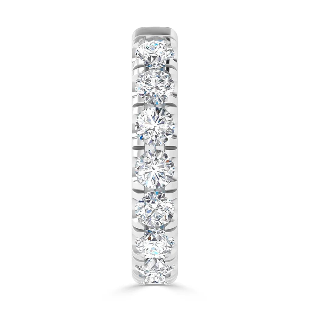Front view of a white gold ring set with seven round, sparkling diamonds in a vertical row.