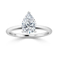 Pear-shaped diamond solitaire ring set on a simple, polished white gold or platinum band.