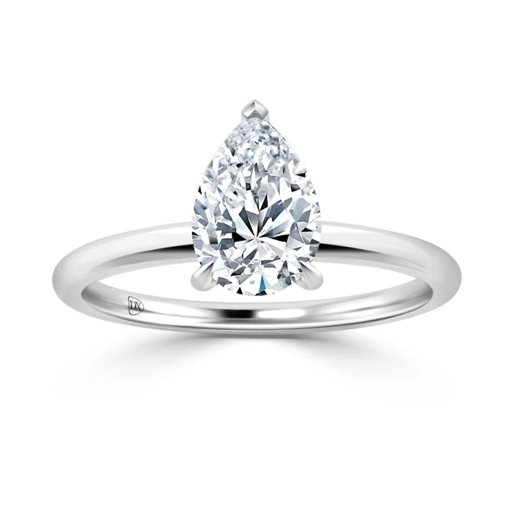 Pear-shaped diamond solitaire ring set on a simple, polished white gold or platinum band.