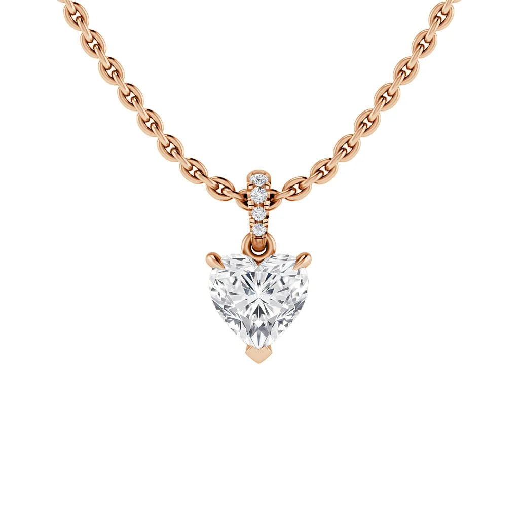 Rose gold chain necklace with a heart-shaped diamond pendant and three small diamonds above the main gem.