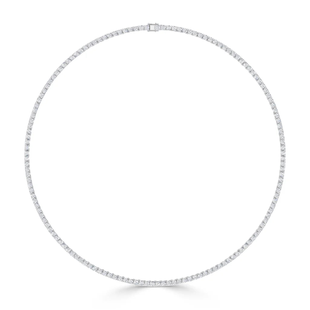 A thin, circular diamond tennis necklace with a uniform design, set against a plain white background.