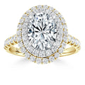 Oval diamond ring with double halo and side diamonds set in yellow gold with a split shank band.